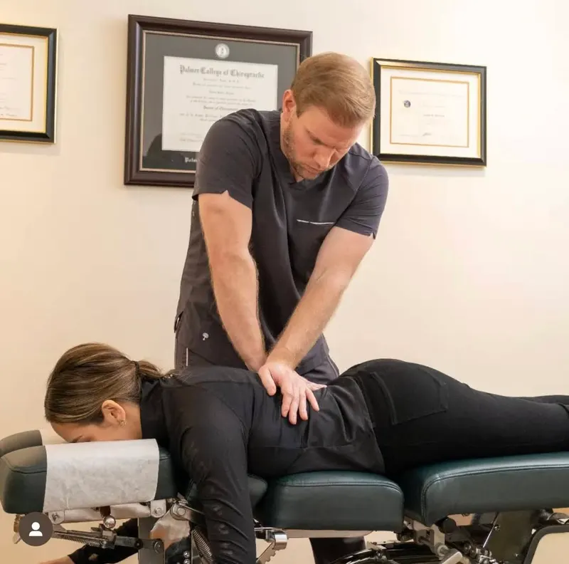 Dr. Jason adjusting a patient on a chiropractic table