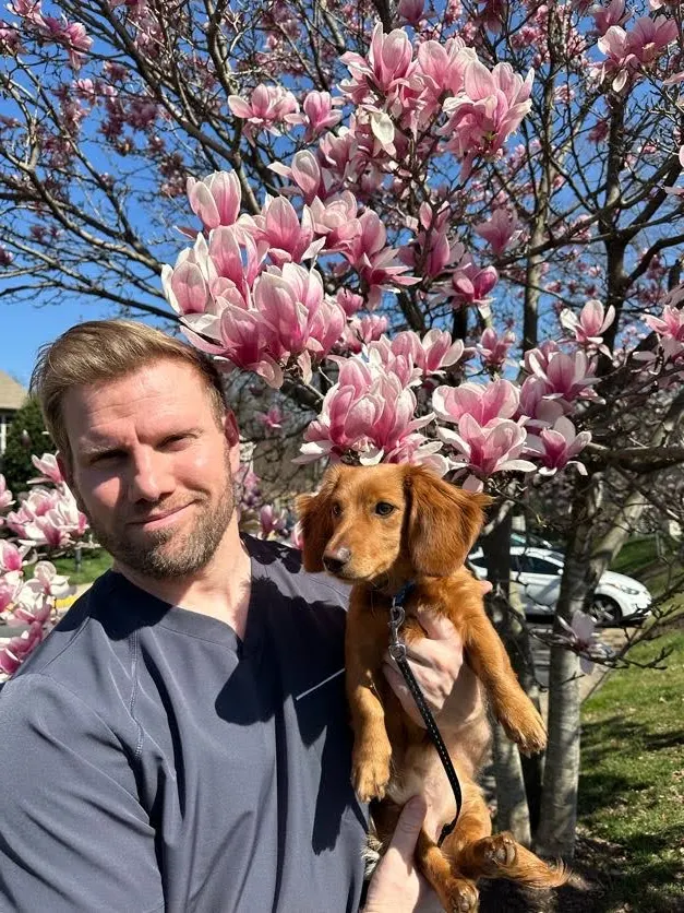 Dr. Jason Brown with the office dog, Slinky