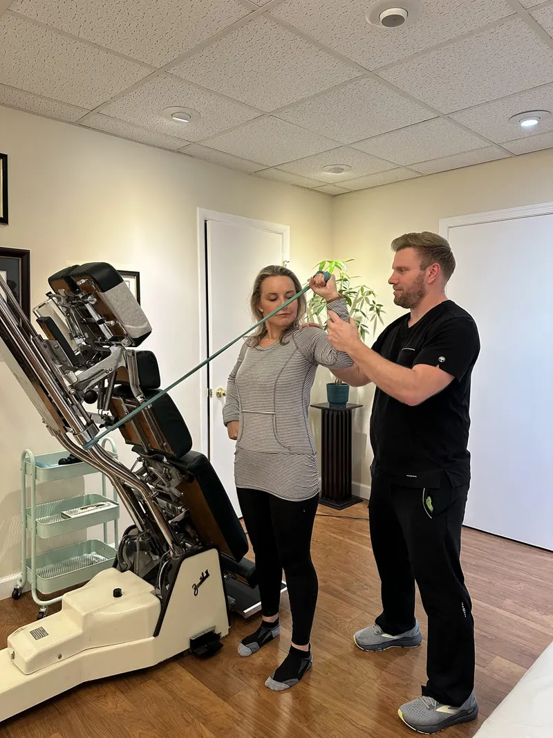 Dr. Jason guiding a patient through a sports rehab exercise